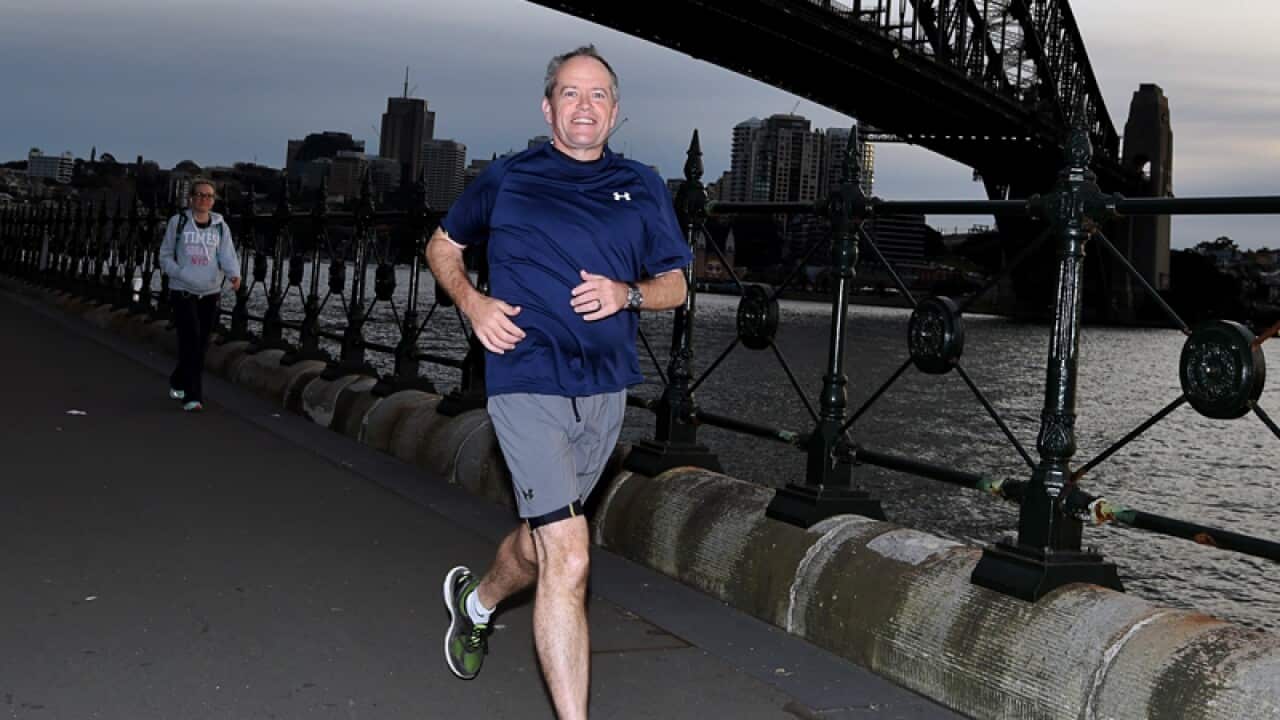 Bill Shorten jogs past the Sydney Harbour Bridge