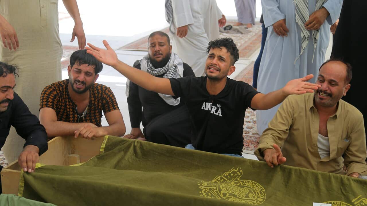 Mourners prepare to bury hospital fire victims in Najaf, Iraq.