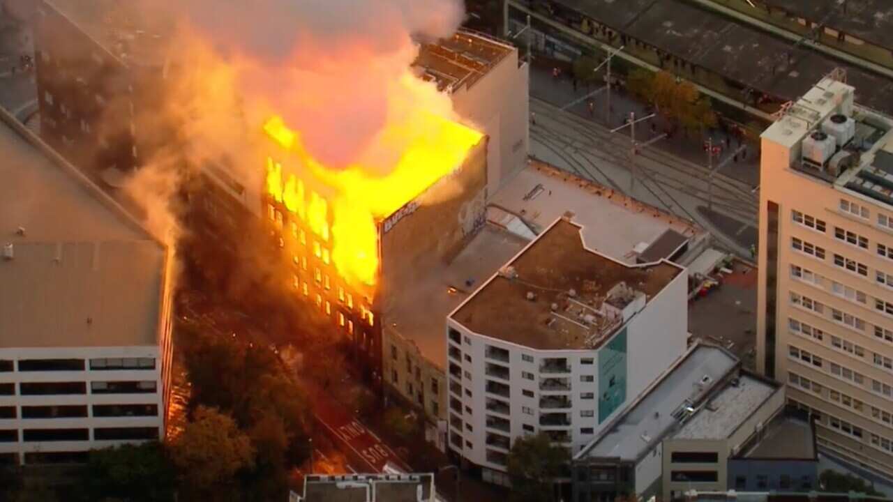 An aerial view of a building on fire.