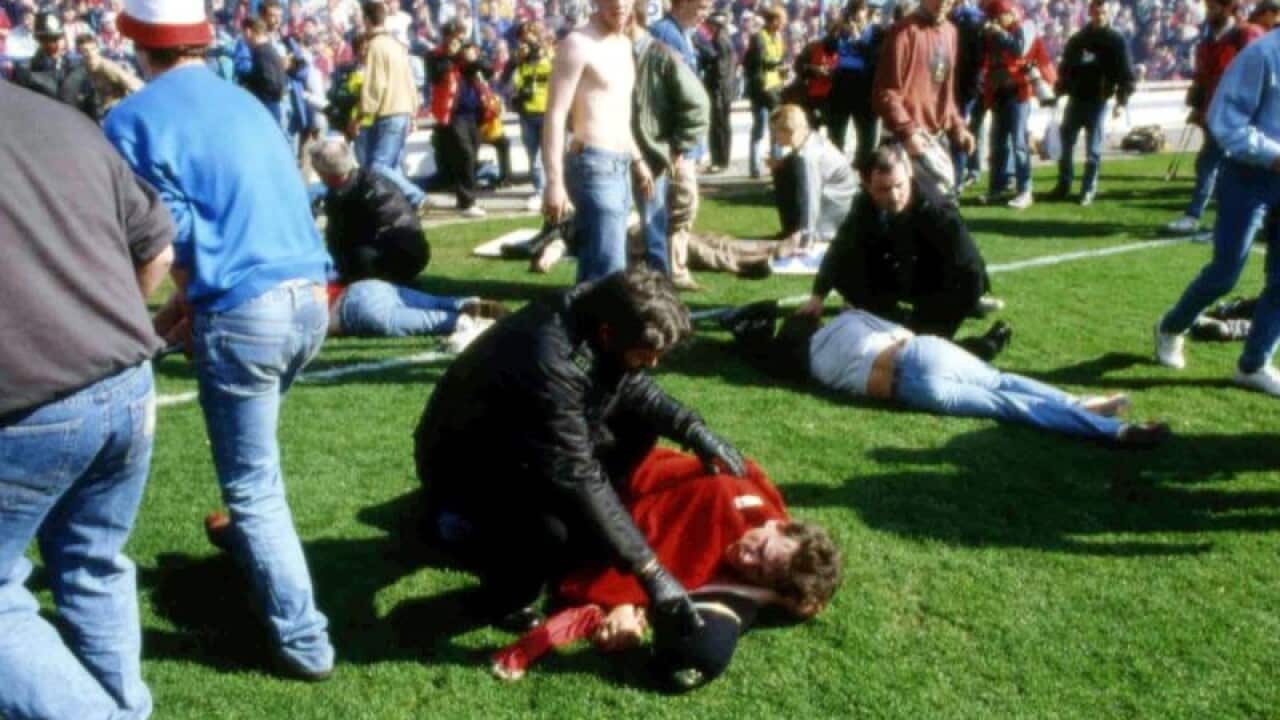 Wounded supporters on the pitch of Hillsborough Stadium