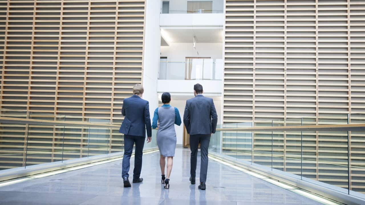 Business people walking on office balcony