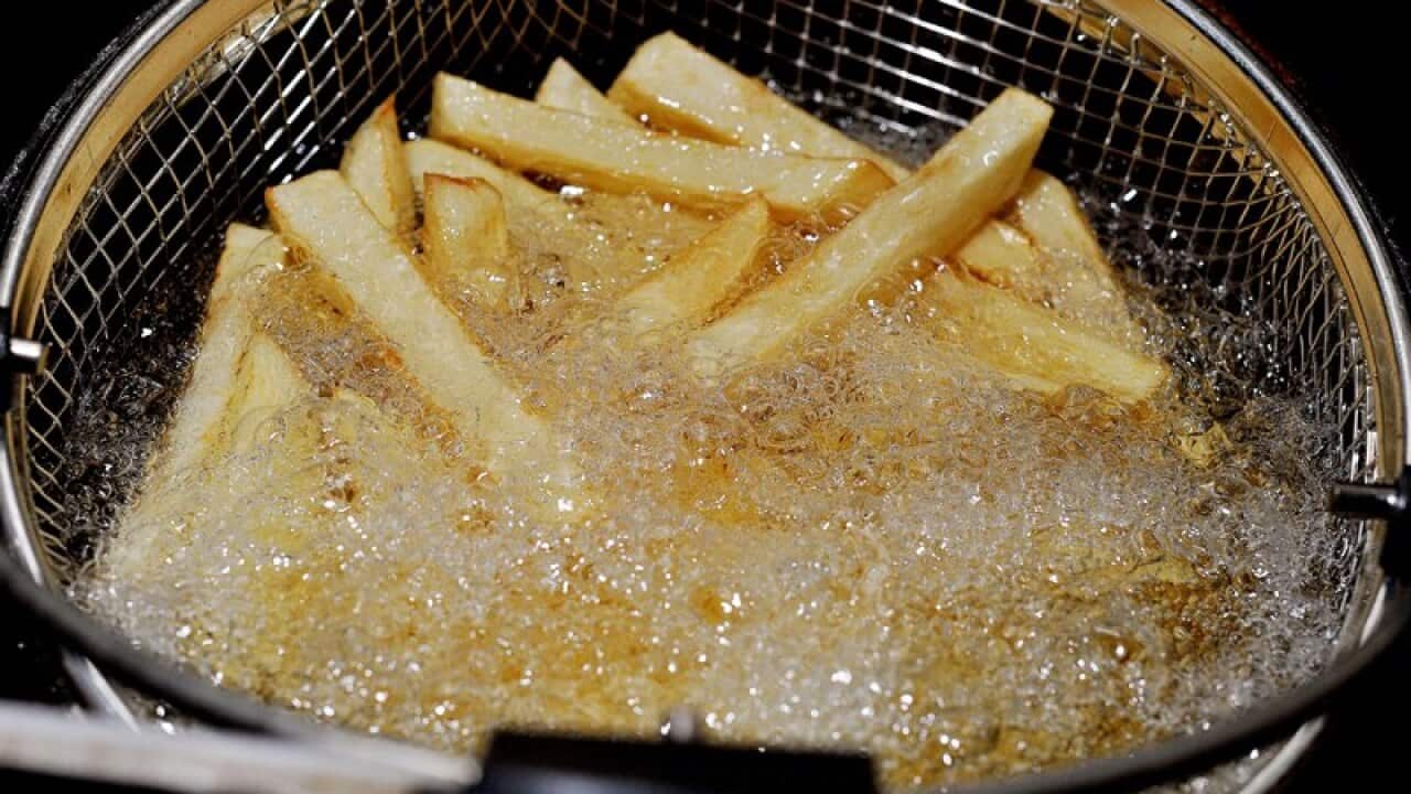 Homemade chips being cooked in a household fat fryer