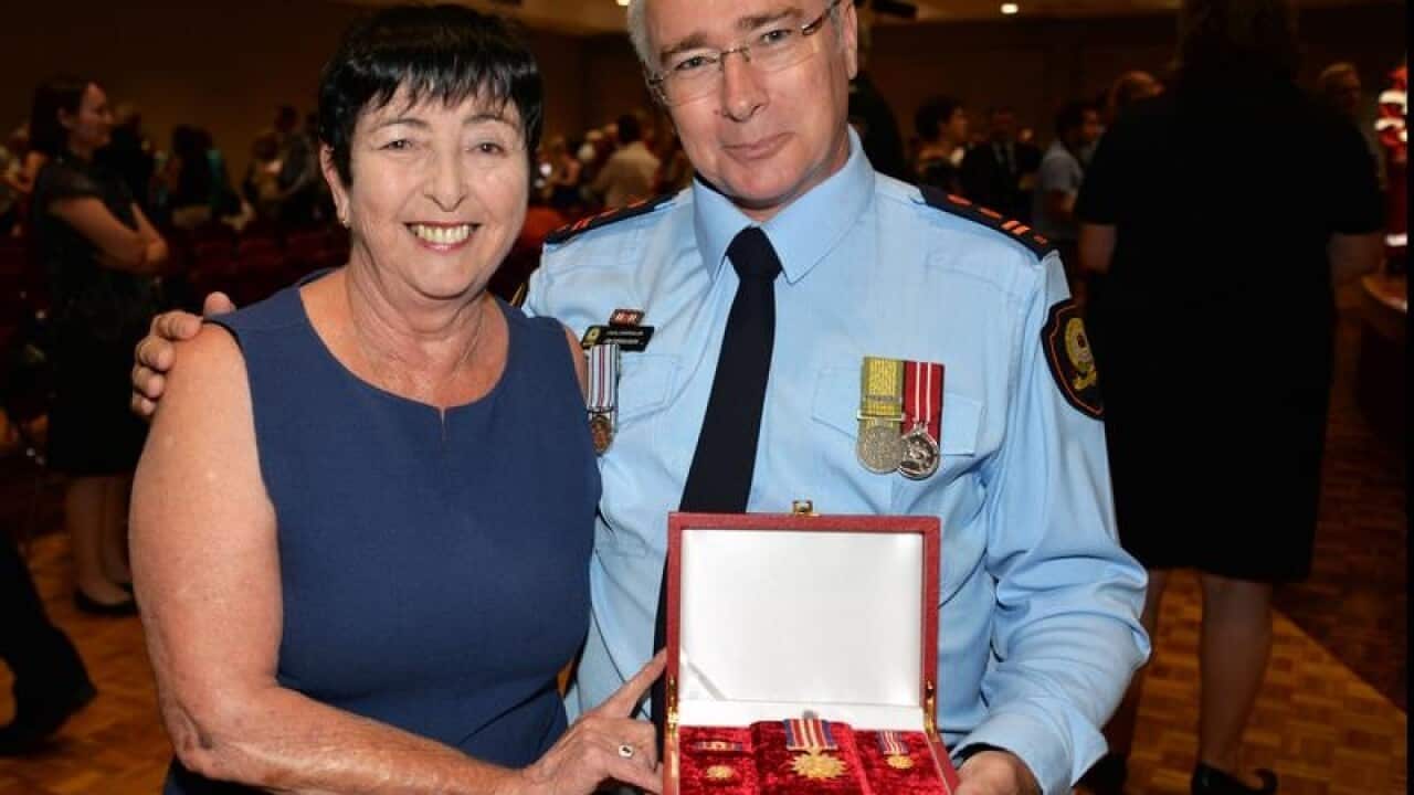 Supplied image of Logan SES Controller Jim Ferguson receiving a medal.