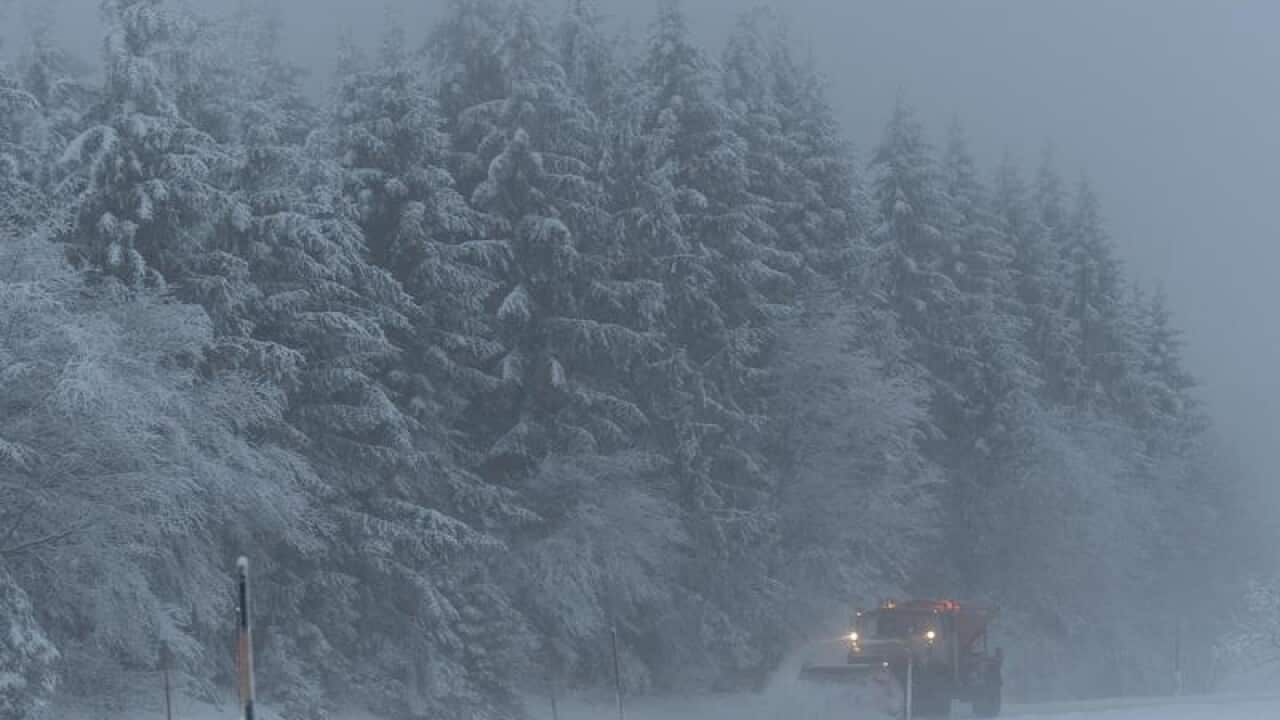 A snow plough clears a road in southern Germany