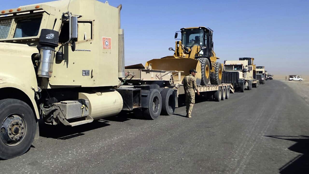 Iraqi security forces are stationed outside the city of Shirqat