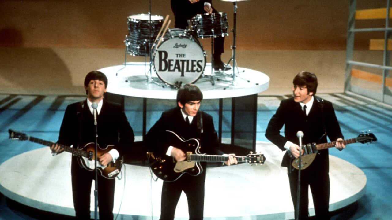 The Beatles perform on the CBS "Ed Sullivan Show" in New York Feb. 9, 1964. From left, front, are Paul McCartney, George Harrison and John Lennon. Ringo Starr plays drums. (AP Photo)