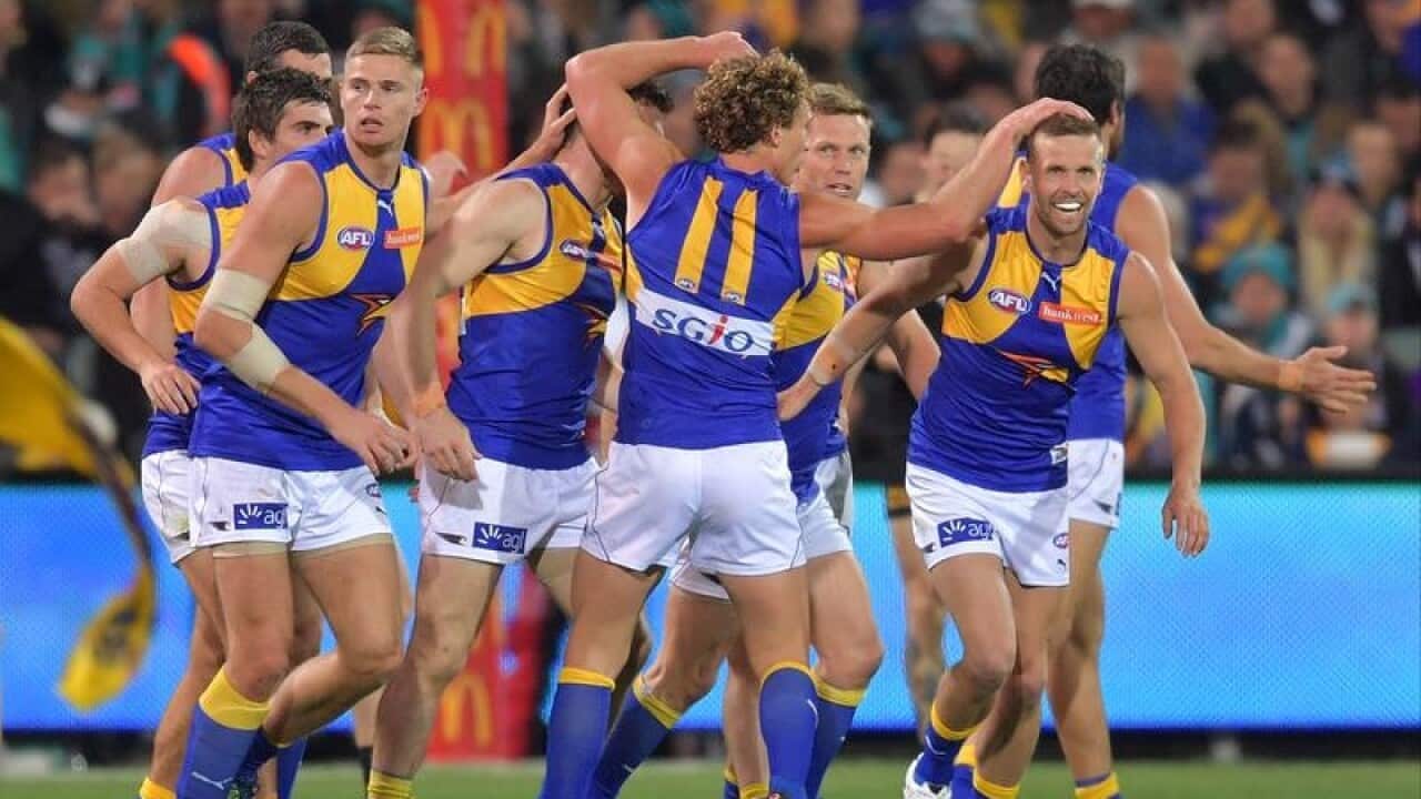 Eagles players celebrate a goal against Port Adelaide