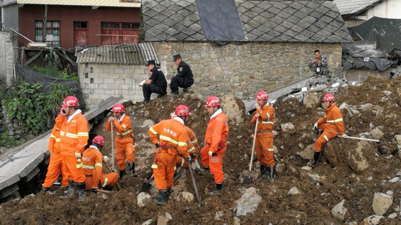Chinese rescue workers are seen at the site of a landslide in Bijie in China's southwestern Guizhou province on August 28, 2017.