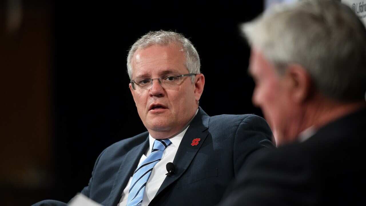Prime Minister Scott Morrison looks on as Mike Munro hosts a Q&A at the Lifeline Australia Luncheon in Sydney, Friday, November 9, 2018. (AAP Image/Joel Carrett) NO ARCHIVING