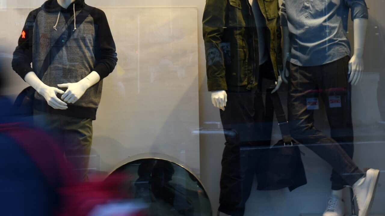 A man walks past a Country Road store.