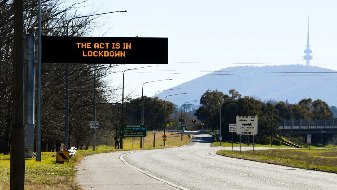 A street sign displays the message The ACT is in lockdown at a main road in Canberra, Friday, 13 August, 2021.