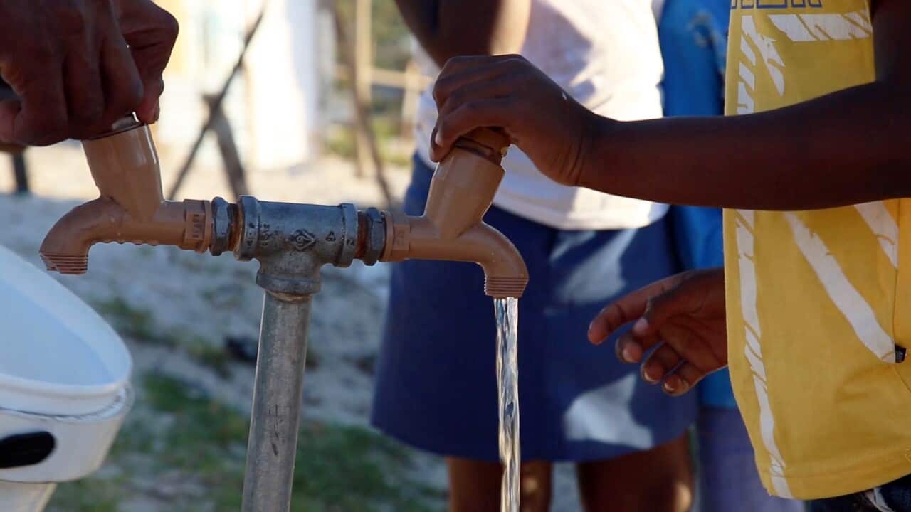 A young boy uses a tap in Khayelitsha, an informal township in Western Cape, South Africa.