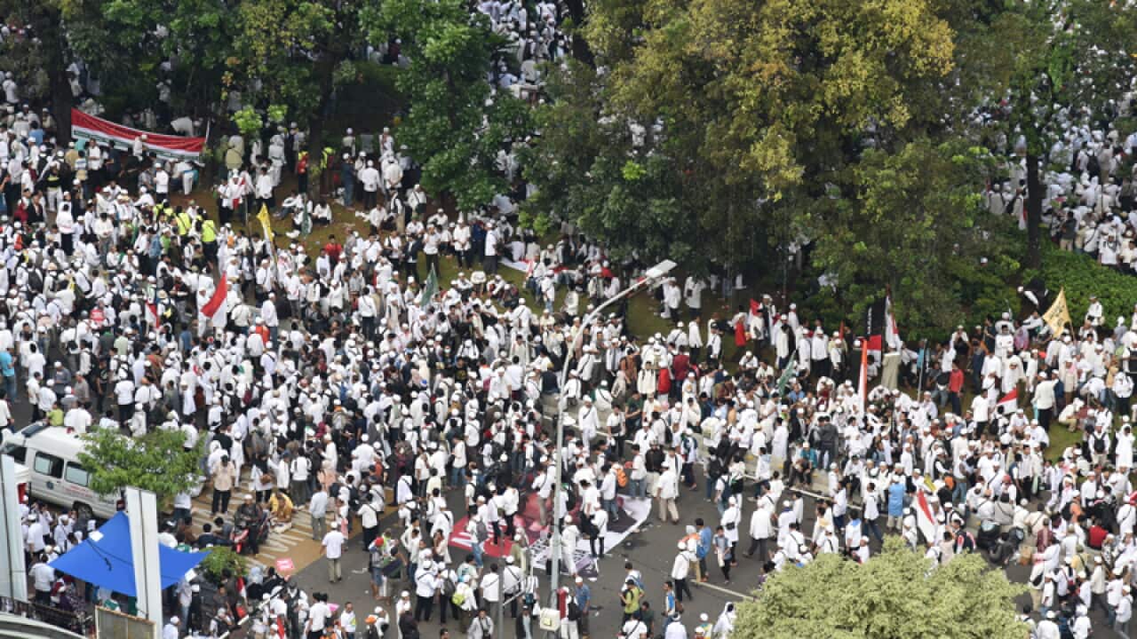 View of the crowd gathering outside the national monument in Jakarta