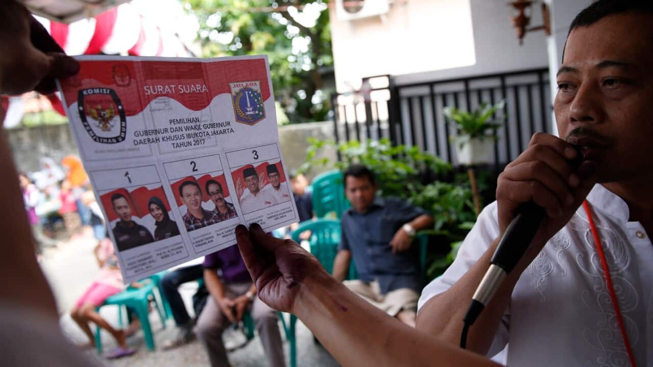 Election workers count ballots at a polling station in Jakarta, Indonesia, 15 February 2017. 