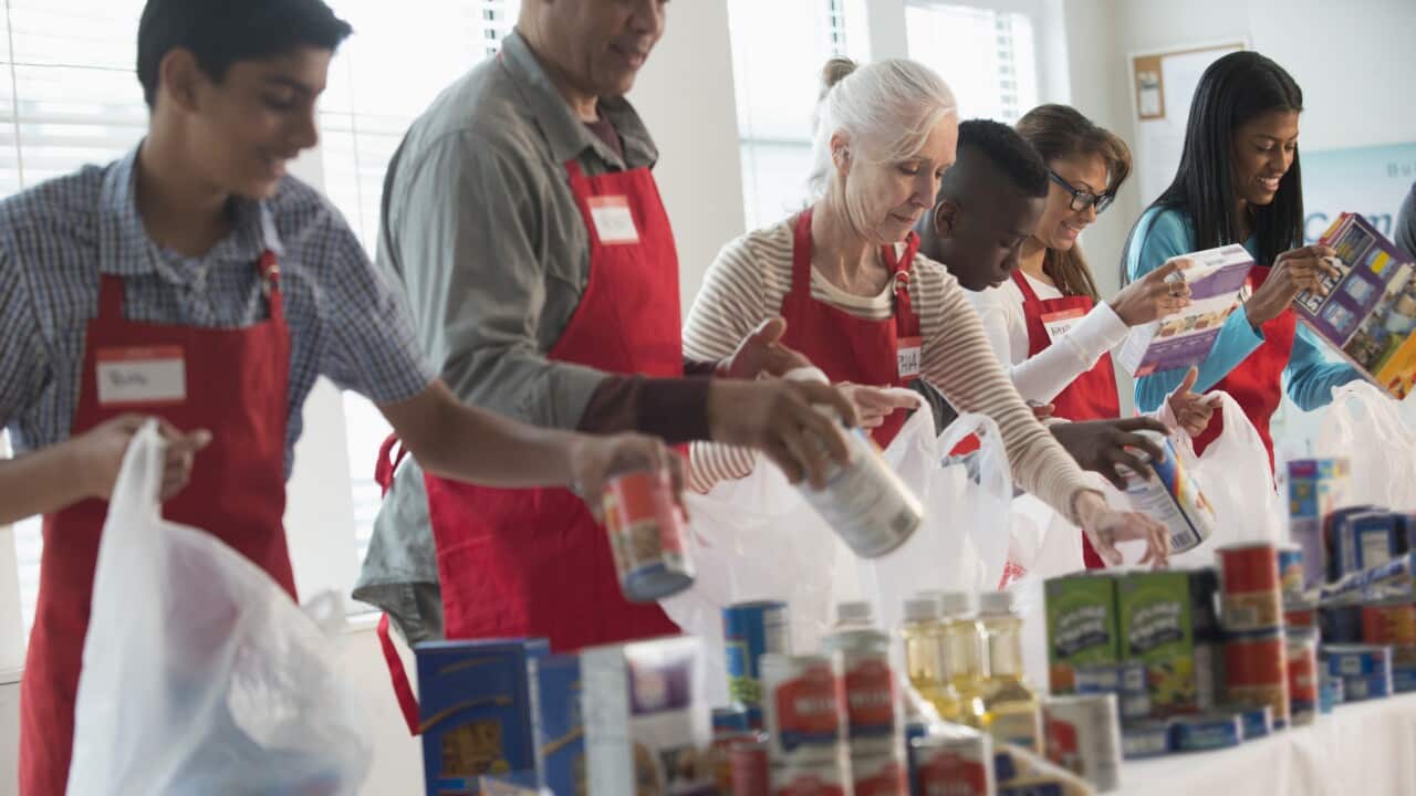 Volunteers packing canned goods at food drive