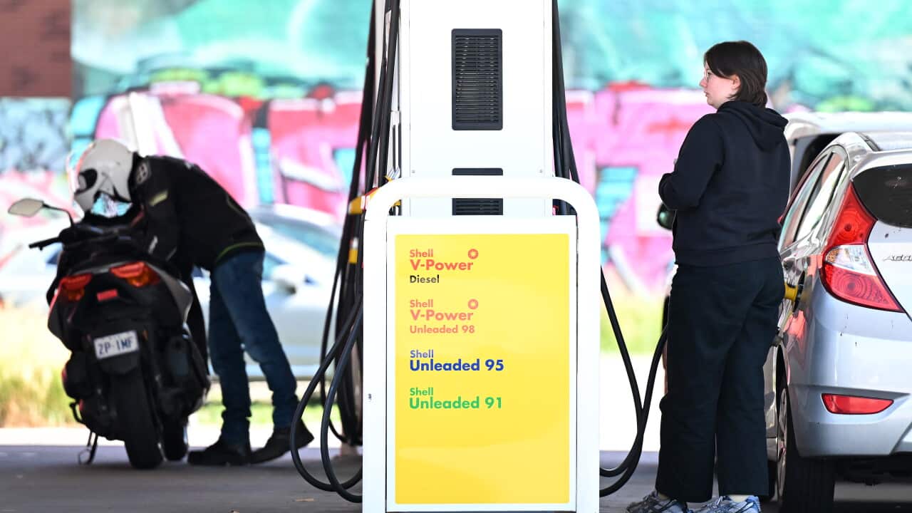 People refuelling their vehicles at a petrol station