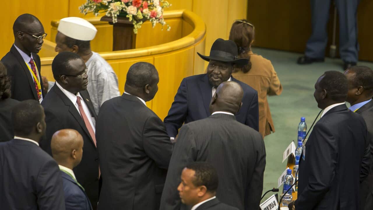 South Sudan's rebel leader Riek Machar, center-left shakes hands with South Sudan's President Salva Kiir, center-right (AP Photo/Mulugeta Ayene)