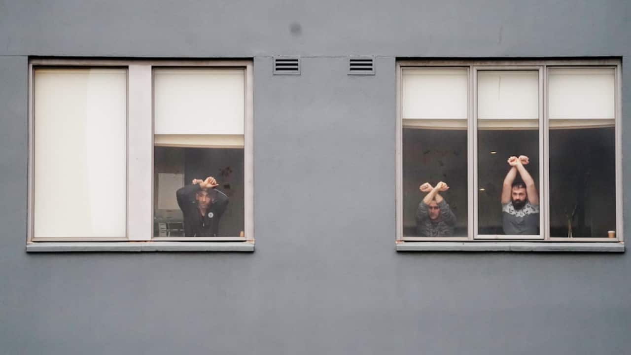 Refugees participate in a "Free The Refugees" rally at the Mantra Hotel in Melbourne.
