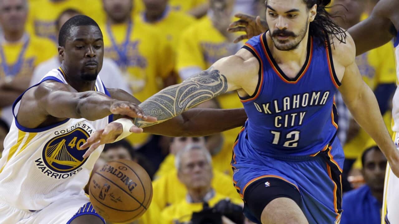 Golden State basketball star Steven Adams (R)