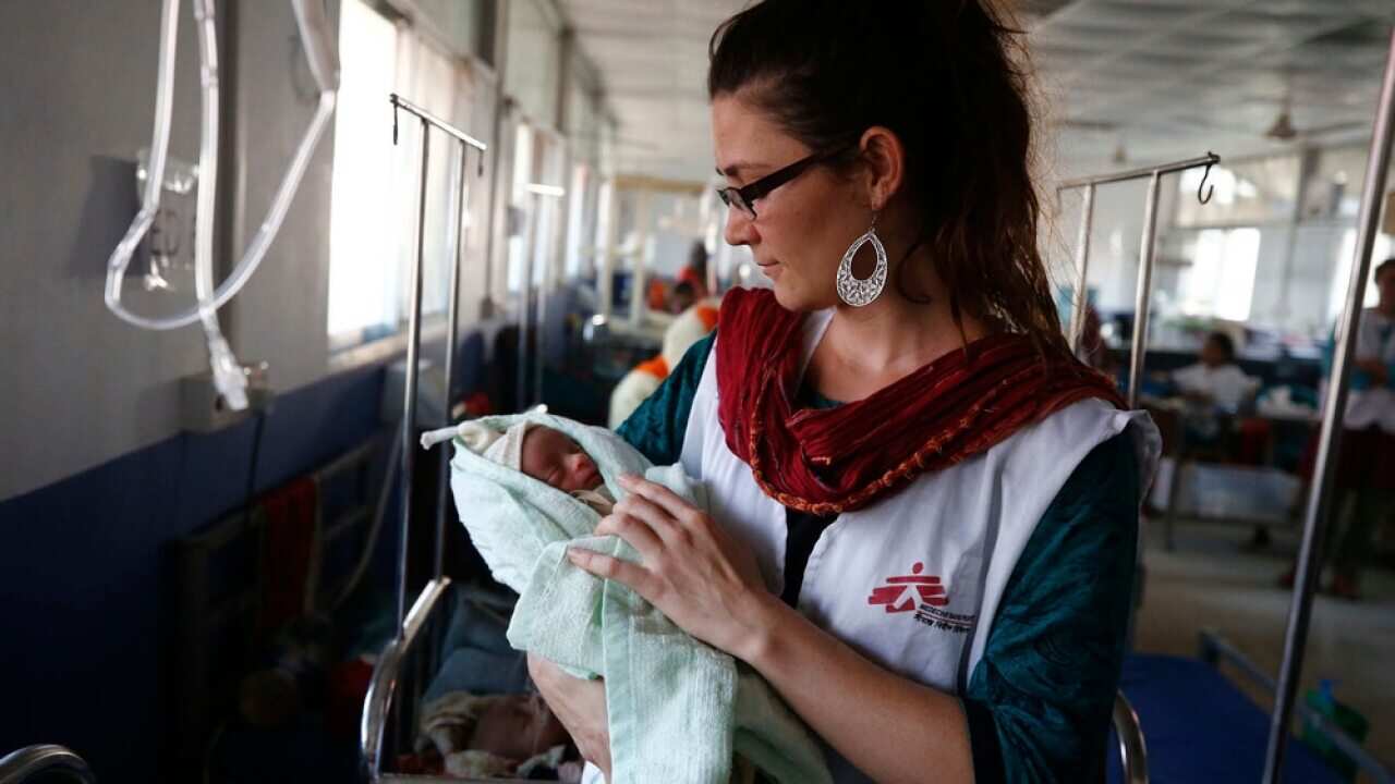 Sophie, an MSF nurse, with a little baby in Kutupalong MSF Hospital.