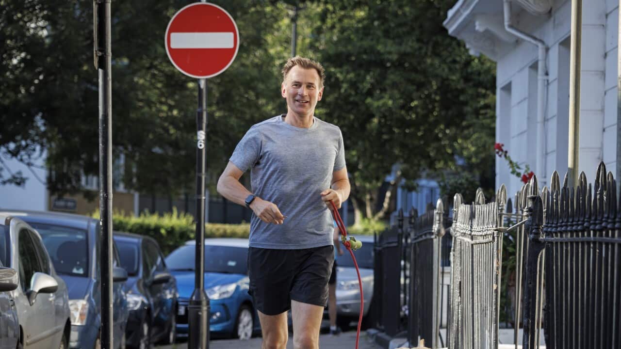 Jeremy Hunt running with dog.