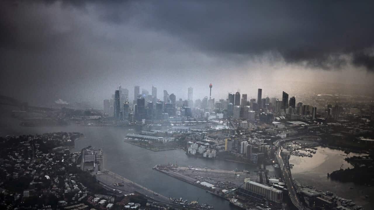 Gray city urban skyline, rain clouds fog at night, aerial view