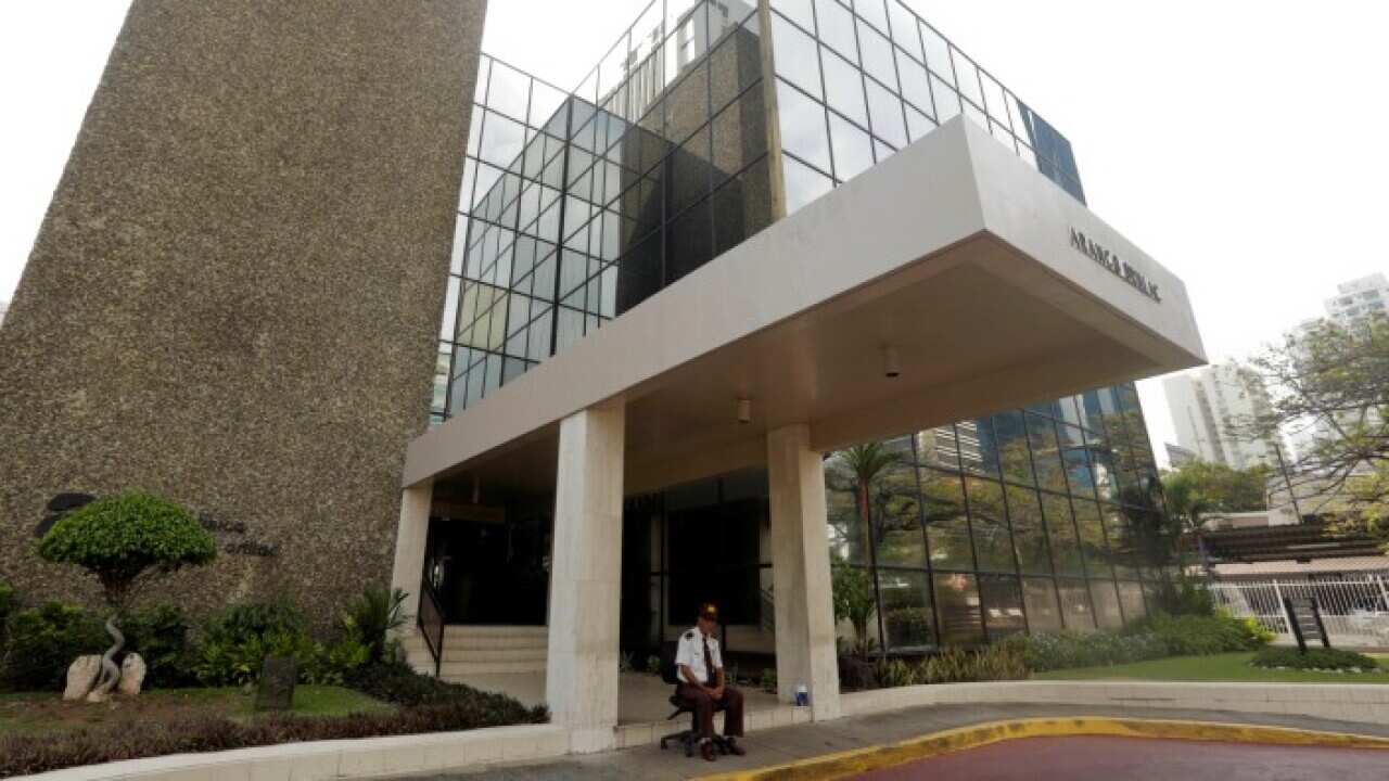 A security guard sit outside the the Mossack Fonseca law firm in Panama City
