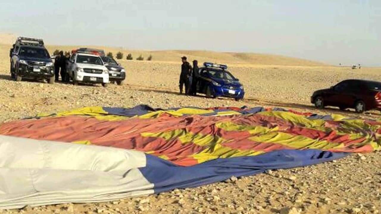 Police officers inspect the site of the hot air balloon crash landing