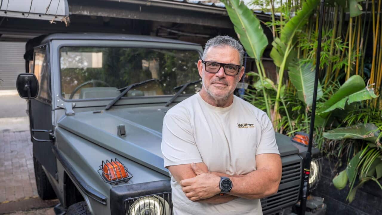 Dr Adrian Cohen with his battery powered cross-country vehicle (SBS-Spencer Austad).jpg