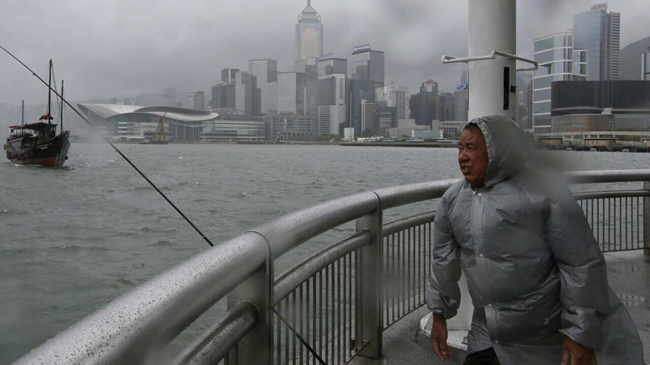 A man battles strong winds as typhoon Usagi approaches