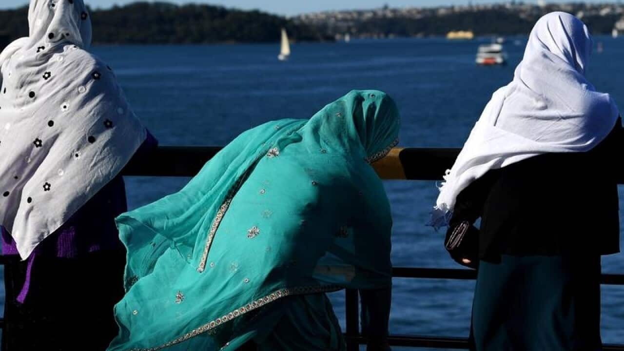 A group of women in colourful headscarves