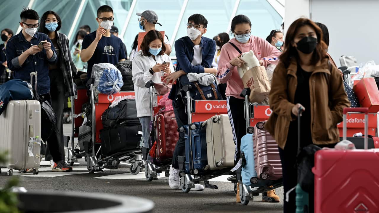 International students wear face masks as they arrive at Sydney Airport in Sydney, Monday, 6 December, 2021.