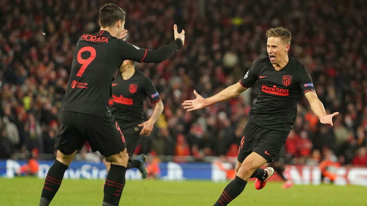 Atletico Madrid's Marcos Llorente, right, celebrates after scoring his side's second goal during a second leg, round of 16, Champions League soccer match between Liverpool and Atletico Madrid at Anfield stadium in Liverpool, England, Wednesday, March 11,.
