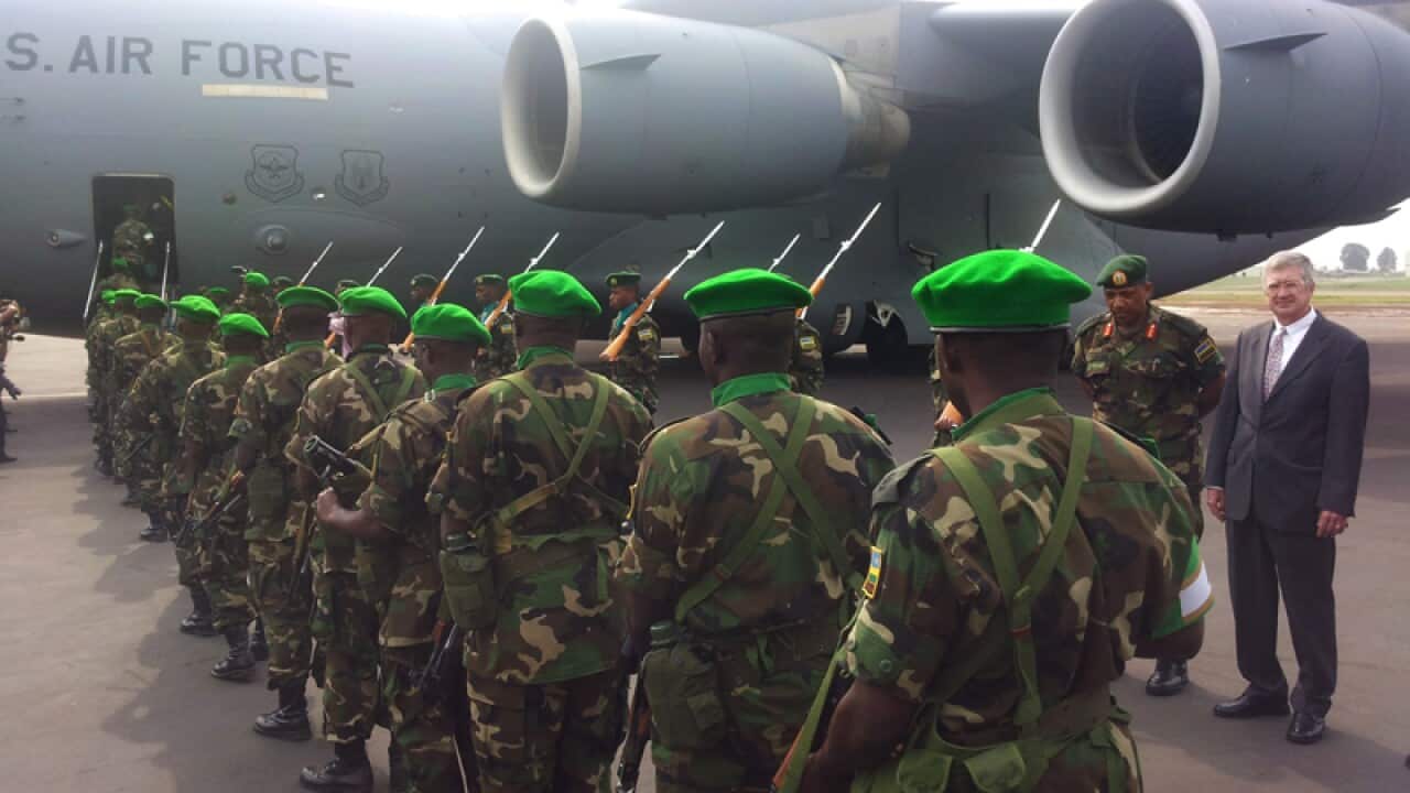 Rwandan troops prepare to board a US military aircraft