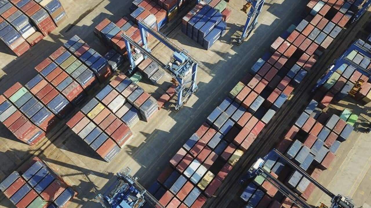 Stacks of containers to be shipped abroad are seen at a port.