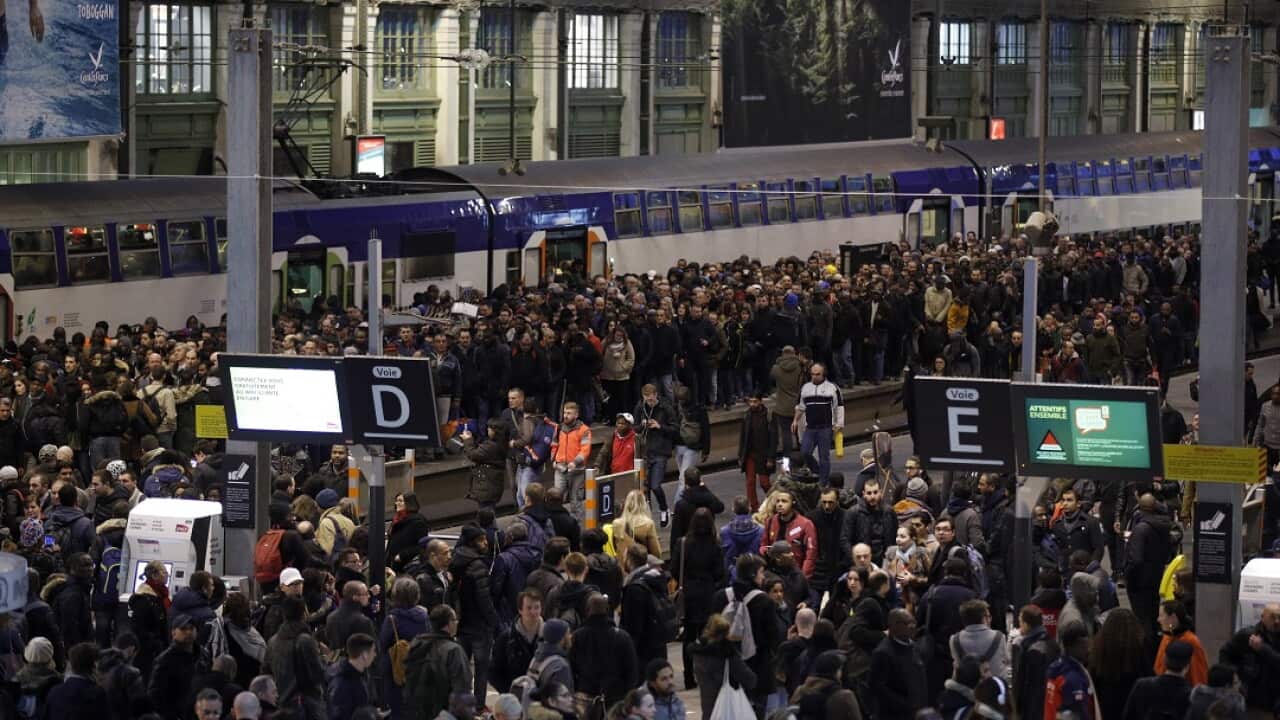 Commuters wait at rush hour at Gare de Lyon train station in Paris.