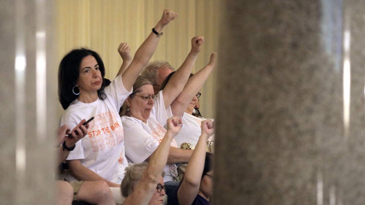 Abortion rights activists seated in the Missouri House react after lawmakers approved the sweeping piece of anti-abortion legislation.