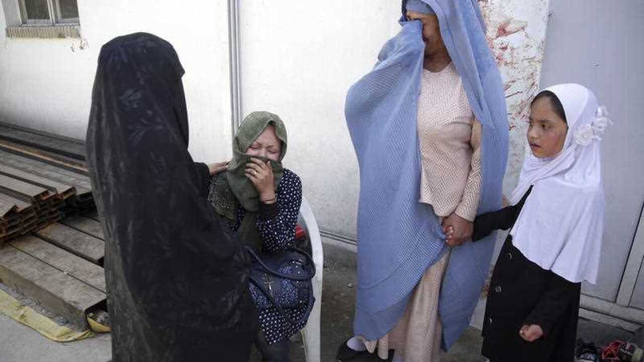 Women cry in a hospital after they lost their children in a deadly suicide attack on a voter registration center in Kabul, Afghanistan, Sunday, April 22, 2018.