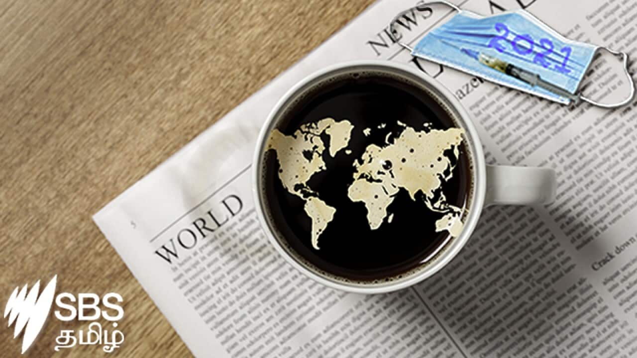 World map in a cup of coffee on a newspaper