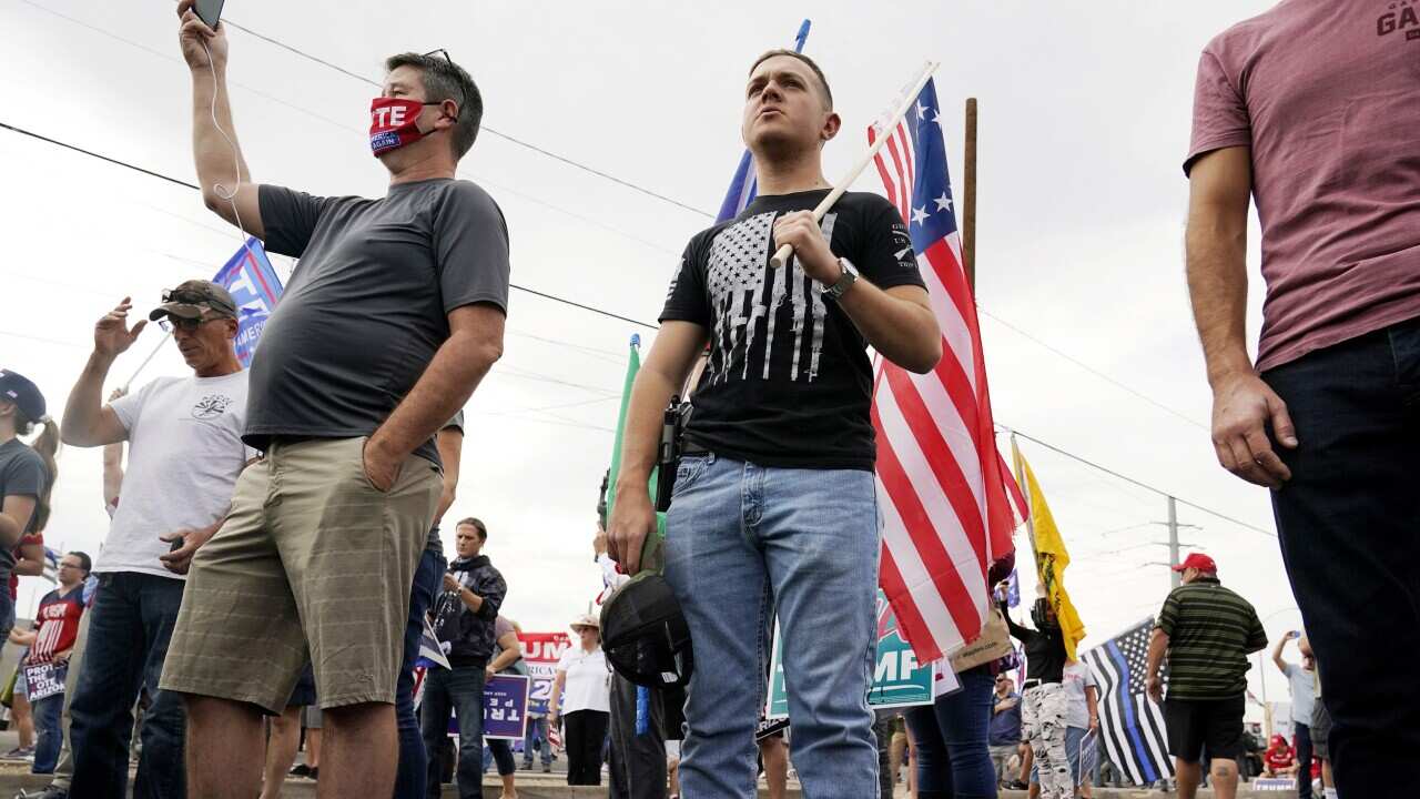 Supporters of President Donald Trump rally outside the Maricopa County Recorder's Office where elections officials continue to count ballots for the general election, Friday, Nov. 6, 2020, in Phoenix. (AP Photo/Ross D. Franklin)