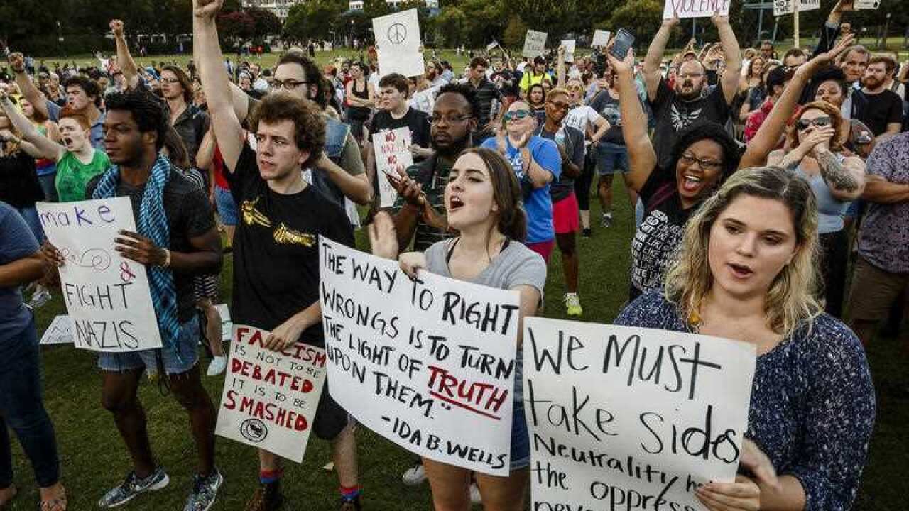 Demonstrators shout during a rally in Coolidge Park in Chattanooga, Tennessee.
