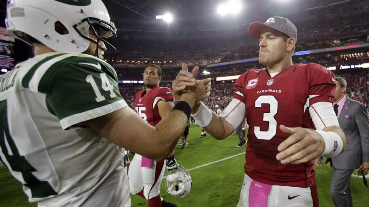 Cardinals' Carson Palmer (3) greets Jets' Ryan Fitzpatrick