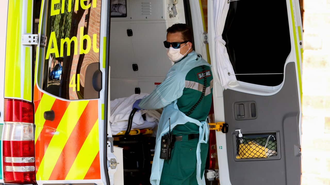 A paramedic wears protective clothing while outside the Mount Barker Hospital in Adelaide.