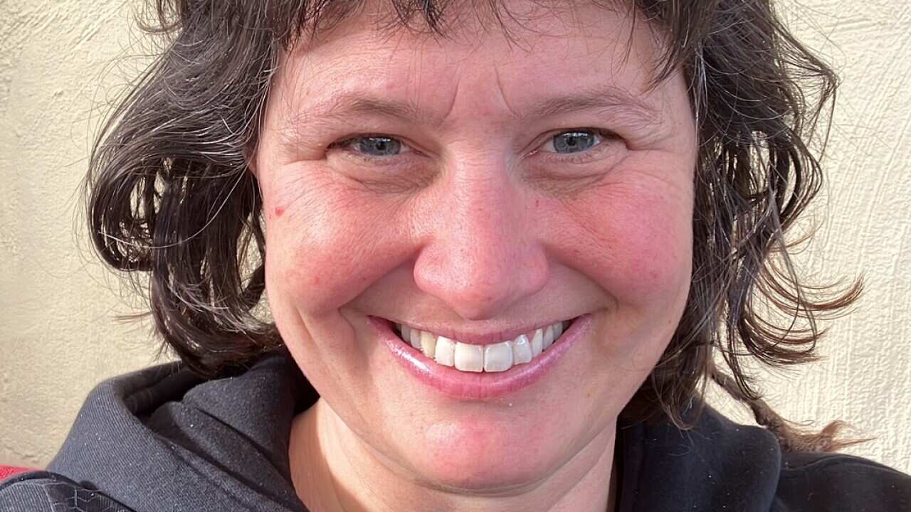 A smiling woman with brown hair