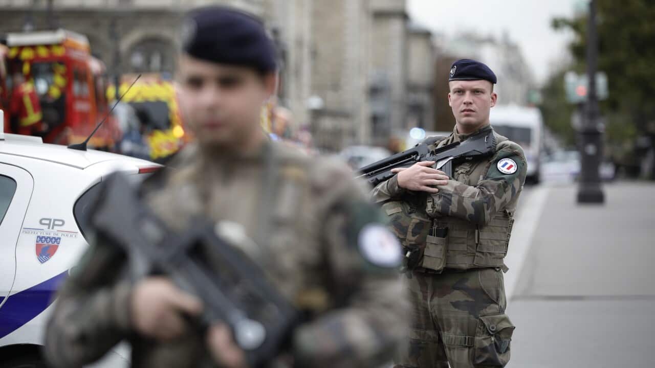 Armed soldiers patrol after an incident at the police headquarters in Paris.