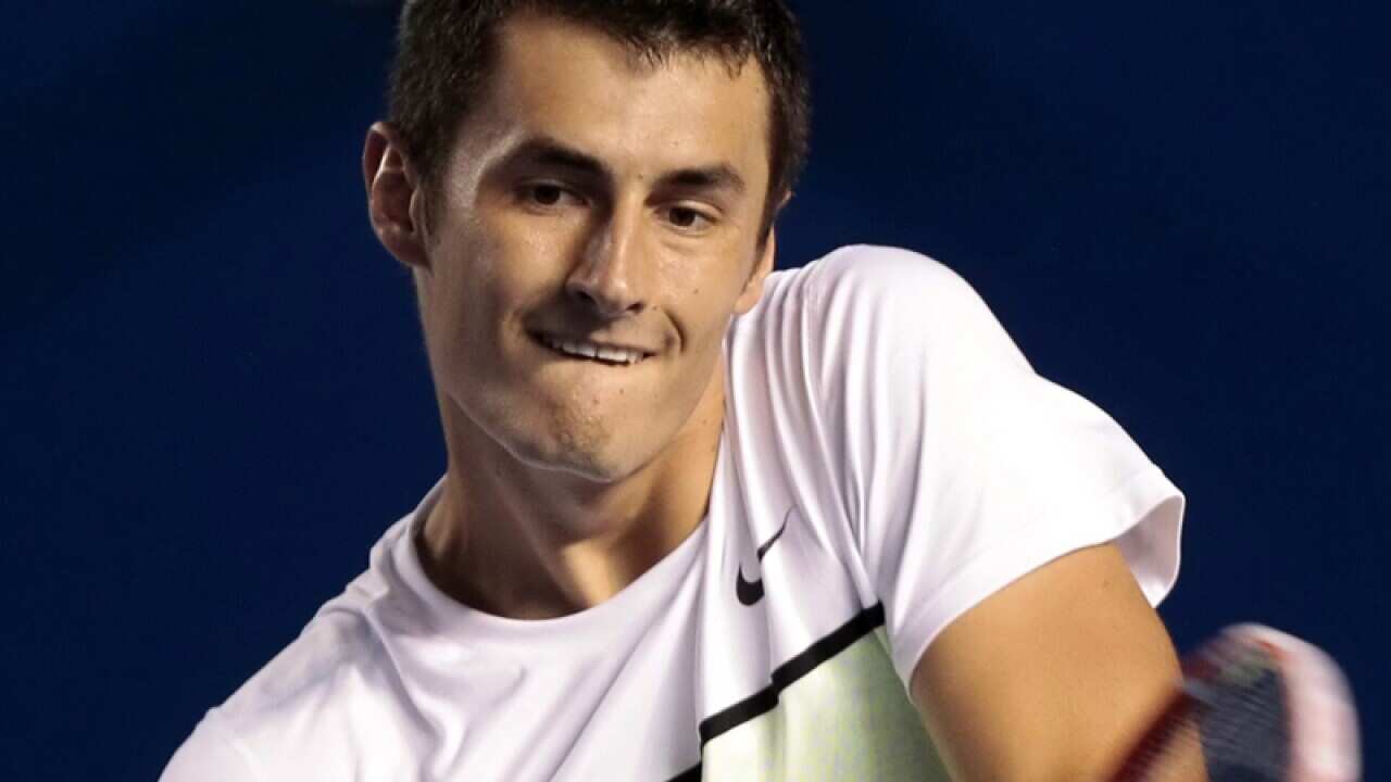 Bernard Tomic of Australia in action against David Ferrer
