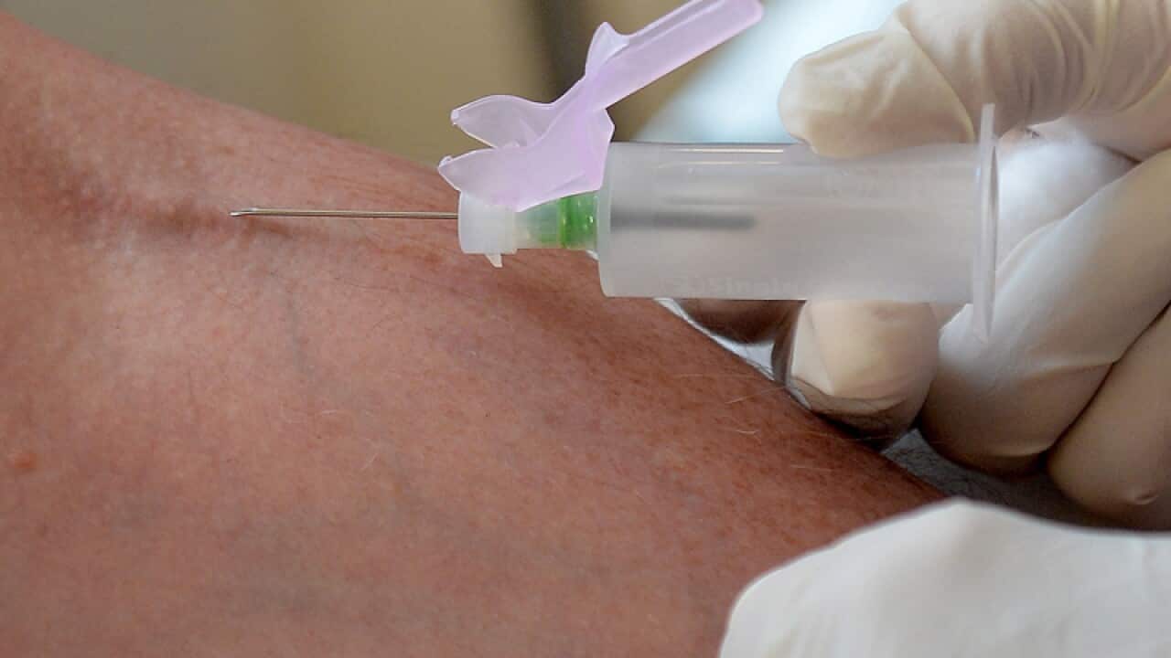 A nurse takes blood from a patient