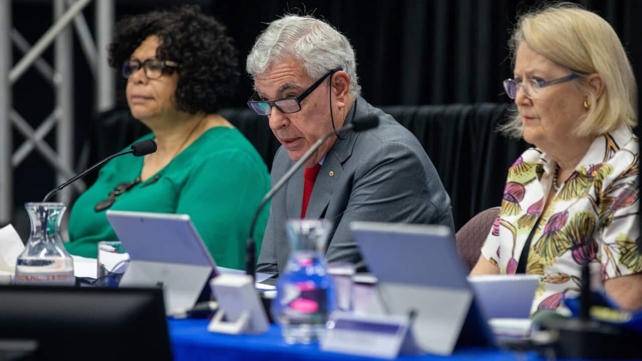 member of the Royal commission sitting at a table t