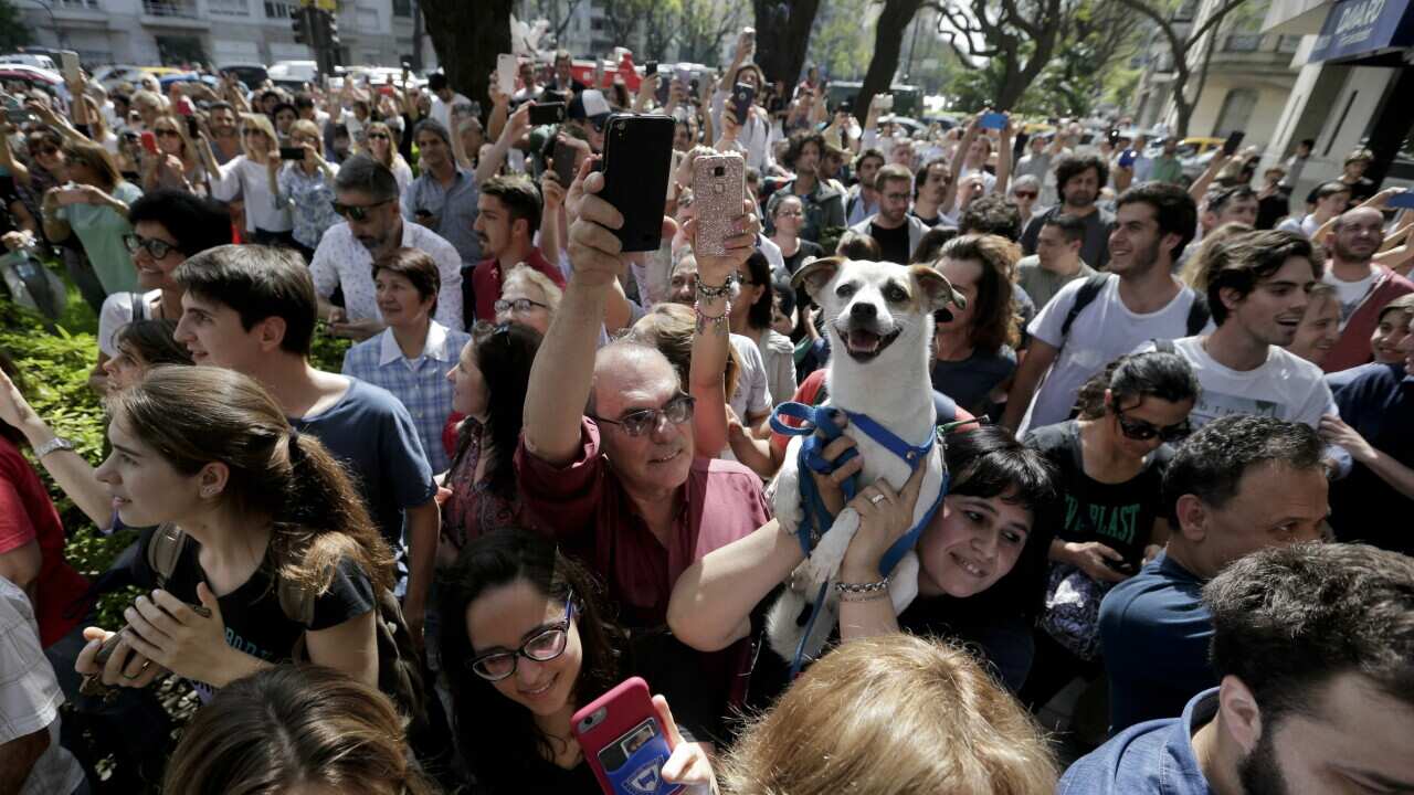 People chant slogans against Argentine lawmaker Julio de Vido