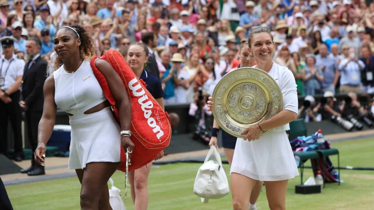 Simona Halep of Romania and Serena Williams of U.S.A. leave the center court after the ladies' singles final of the Championships, Wimbledon